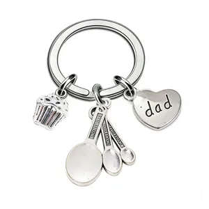 Dad alloy keychain detail featuring cute cupcake and measuring spoons for parent gift.
