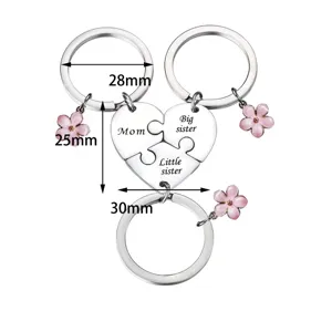 Stainless steel family puzzle keychain set with cute pink flower charms for mother and sisters.