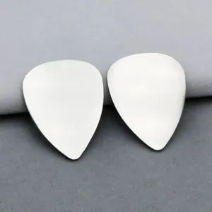 Stainless steel guitar pick detail showing polished metallic surface for custom DIY engraving.