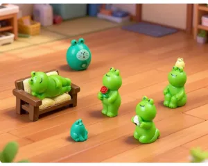 Miniature green frog figurines set, cute resin dollhouse landscape ornaments for desktop decor detail.