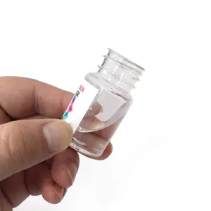 Crystal clear epoxy resin glue liquid detail view, transparent small bottle packaging close-up.