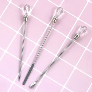 Detail view of nail art tools, featuring crystal handle mixing rods and metal detail needles.