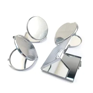 Silver stainless steel compact cosmetic pocket mirror with folding design and details.