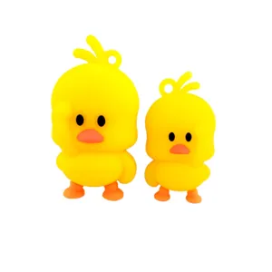 Cute yellow duck pendant detail, soft silicone keychain accessory showing cute saluting pose.