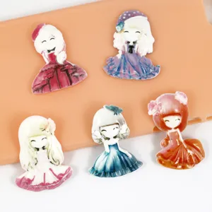 Detailed close-up of cute resin princess doll cabochons for DIY phone case and crafts.