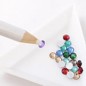 Nail art pick up pen and colorful rhinestones set for DIY manicure crafts and jewelry decoration.