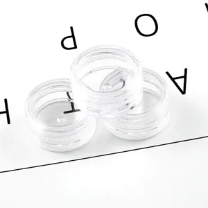 Petite boîte de rangement ronde en acrylique transparent pour paillettes de nail art.