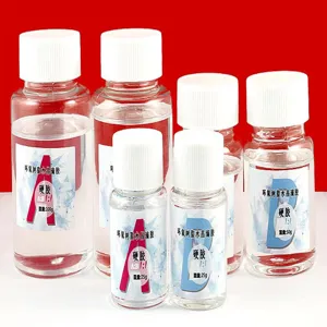 Detailed view of clear epoxy resin crystal glue bottles, 1:1 ratio DIY craft materials.