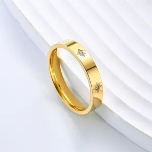 Gold stainless steel ring featuring sparkling crystal star details and polished minimalist finish.