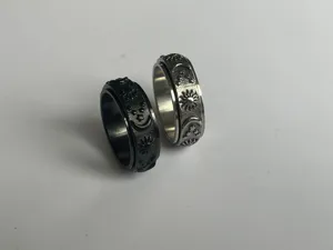 Anello antistress in acciaio inossidabile con dettagli di sole, luna e stelle incisi.