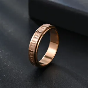 Gros plan détaillé de la bague rotative en acier inoxydable or rose avec chiffres romains.