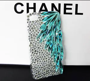 Close-up detail of luxury crystal rhinestone phone case with stunning turquoise teardrop stones.
