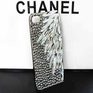 Close-up detail of sparkling crystal rhinestones arranged in an elegant wing pattern on a phone case.