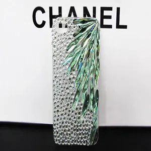 Crystal rhinestone phone case detail showing green teardrop stones and sparkling clear diamonds.