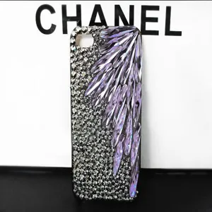 Detailed view of handmade rhinestone phone case with purple crystal wing decoration, sparkling DIY.