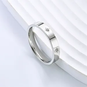 Close-up detail shot of the minimalist titanium steel ring featuring sparkling crystal stones.