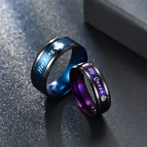 Close up of titanium steel couple rings with Her King and His Queen engraved details.