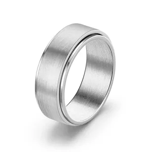 Closeup view of a brushed stainless steel spinner ring, featuring a sleek polished edge.