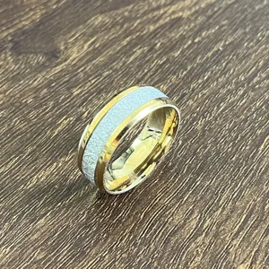 Bague en acier inoxydable avec biseaux dorés et texture givrée, bijoux tendance unisexe.