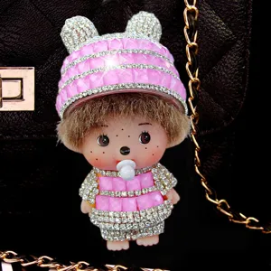 Close-up detail view of the sparkling rhinestone doll keychain charm with pink hat.