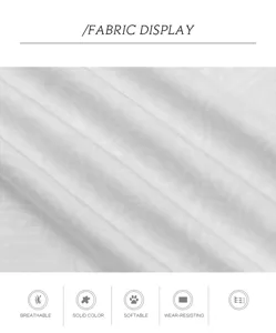 Gros plan sur le détail du tissu montrant une texture textile blanche respirante.