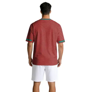 Heren korte mouw voetbalshirt in rood golfdesign met groene accenten en witte shorts achterkant.