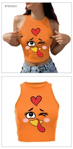 Detailed view of the orange cropped tank top showcasing a cute cartoon turkey and red heart graphic.