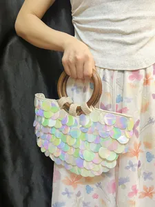 Spring summer iridescent sequin shell handbag with wooden ring handle, detailed view.