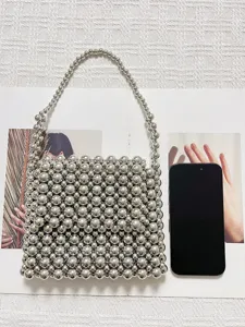 Detail view of a fashionable silver beaded handbag, chic mini woven tote bag for summer.