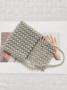 Detail view of the silver beaded mini woven handbag highlighting exquisite metallic bead texture.