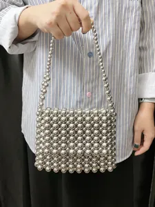 Silver metallic beaded handbag detail, shiny small woven tote bag for trendy summer style.