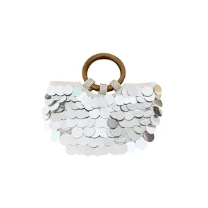 Chic sequin shell evening handbag with wooden handle and shimmering silver fish scale design.
