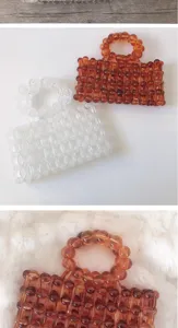 Close-up detail of handmade beaded handbag featuring unique amber and clear acrylic beads.