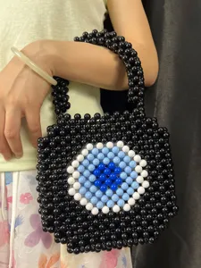 Handmade beaded woven handbag with trendy evil eye design, black square shoulder tote bag.