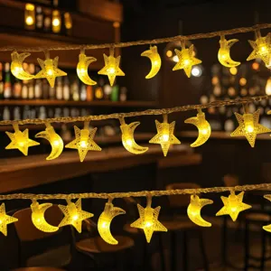 Close-up of warm yellow LED star and moon string lights for cozy room decor and outdoor patio use.