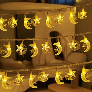 Close-up detail of warm LED star and moon fairy string lights creating cozy room ambiance.