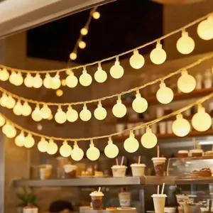 Warm white LED globe string lights, perfect for outdoor patio, camping, and cozy room decor.