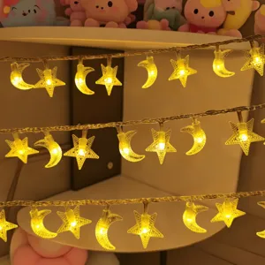 LED star and moon string lights detail view, warm yellow ambient lighting for children room decor.
