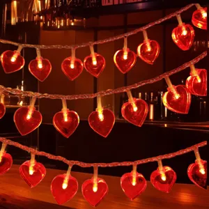 Close-up of glowing red heart LED string lights, warm romantic decorative mood lighting detail.