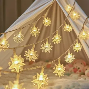 Detail shot of warm LED star string lights, perfect for cozy room decor and outdoor camping vibes.