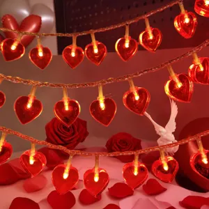 Close-up view of red heart LED string lights creating romantic valentine atmosphere warmly.