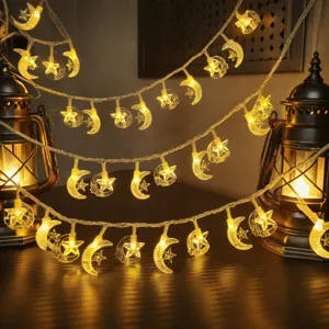 Detail view of warm LED star and moon fairy string lights for cozy room ambient lighting.