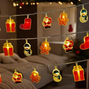 Close up view of warm LED Christmas string lights featuring cute holiday pendants in a cozy room.