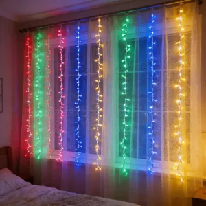 LED curtain string lights hanging on window for bedroom decoration, colorful fairy lights setup.