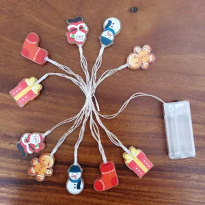 Christmas LED string lights with cute acrylic pendants like snowman and Santa for holiday decor.