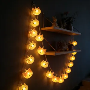 LED cat string lights detail, warm glowing cute cat face lights for bedroom decor ambience.