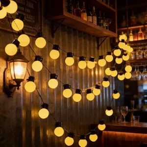 Detailed view of warm glow LED globe string lights creating cozy atmosphere for indoor and outdoor spaces.