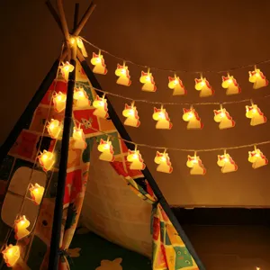 Close-up detail of warm LED unicorn string lights hanging for cozy bedroom decoration.