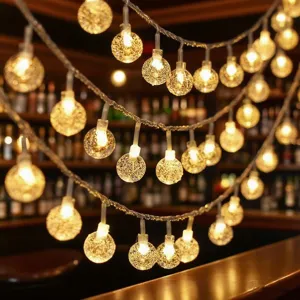 Warm LED crystal ball string lights detail, glowing decorative fairy lights for room indoor setup.