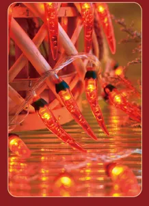 Close-up detail of glowing red chili LED lights for cozy festive room decor and holidays.